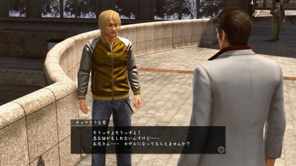 Kiryu talks to the man who invites him to work as a model in Yakuza Kiwami 2