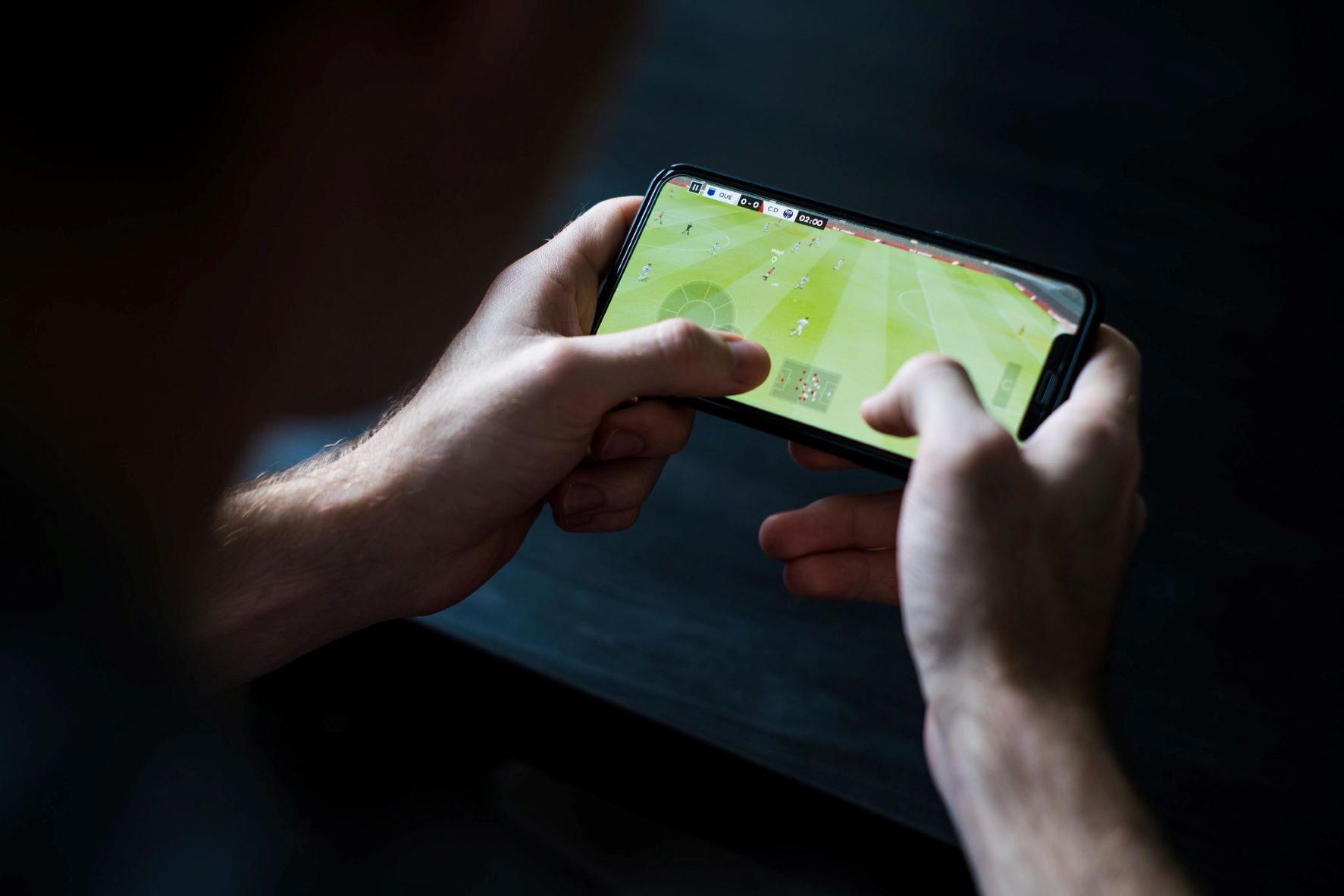 Person playing soccer on a phone. Flickr archive (Creative Commons).